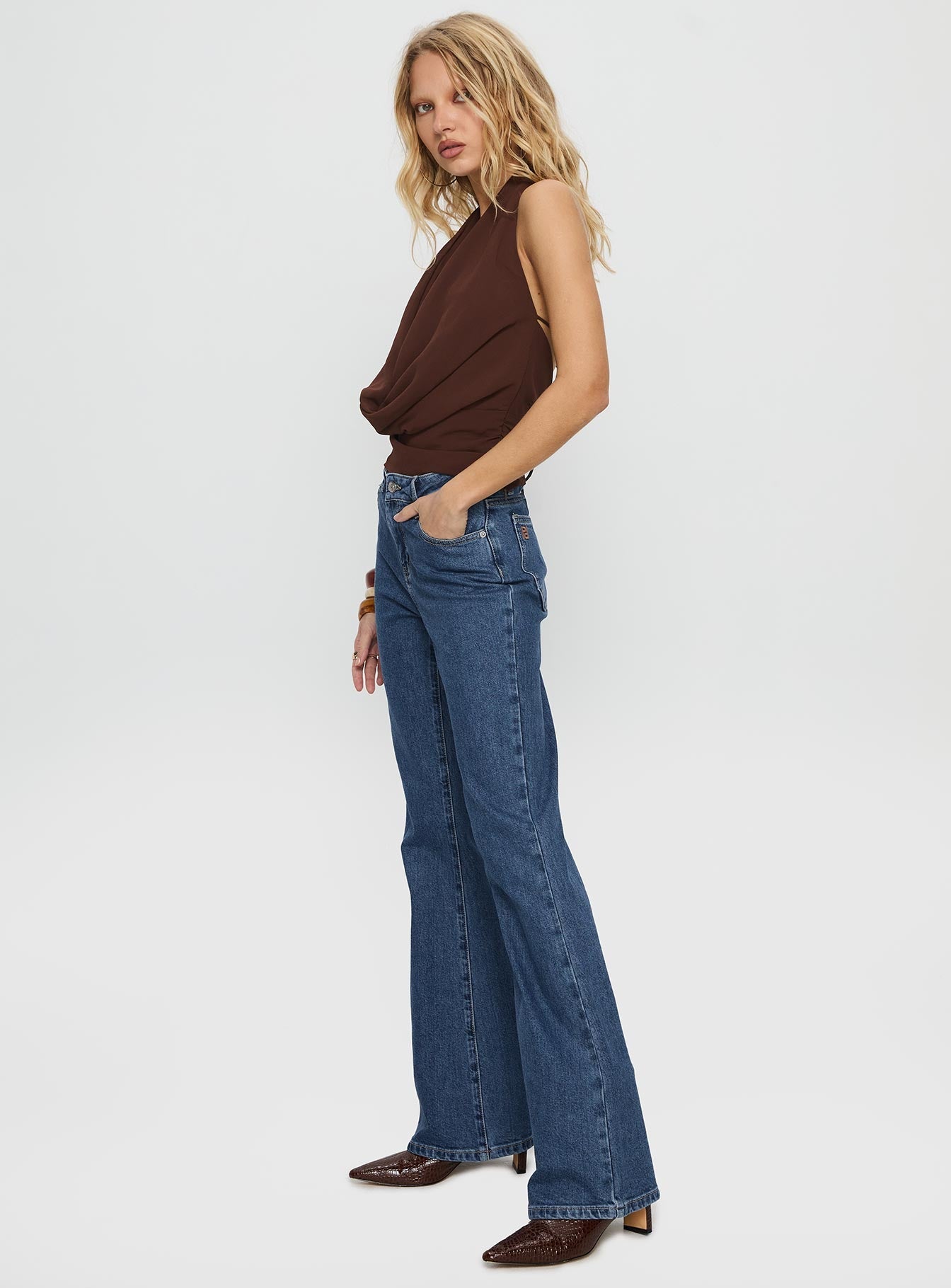 side view of model wearing Princess Polly Magic Mirror Mid Rise Bootleg Jeans Mid Blue Wash Mid Rise Jeans 