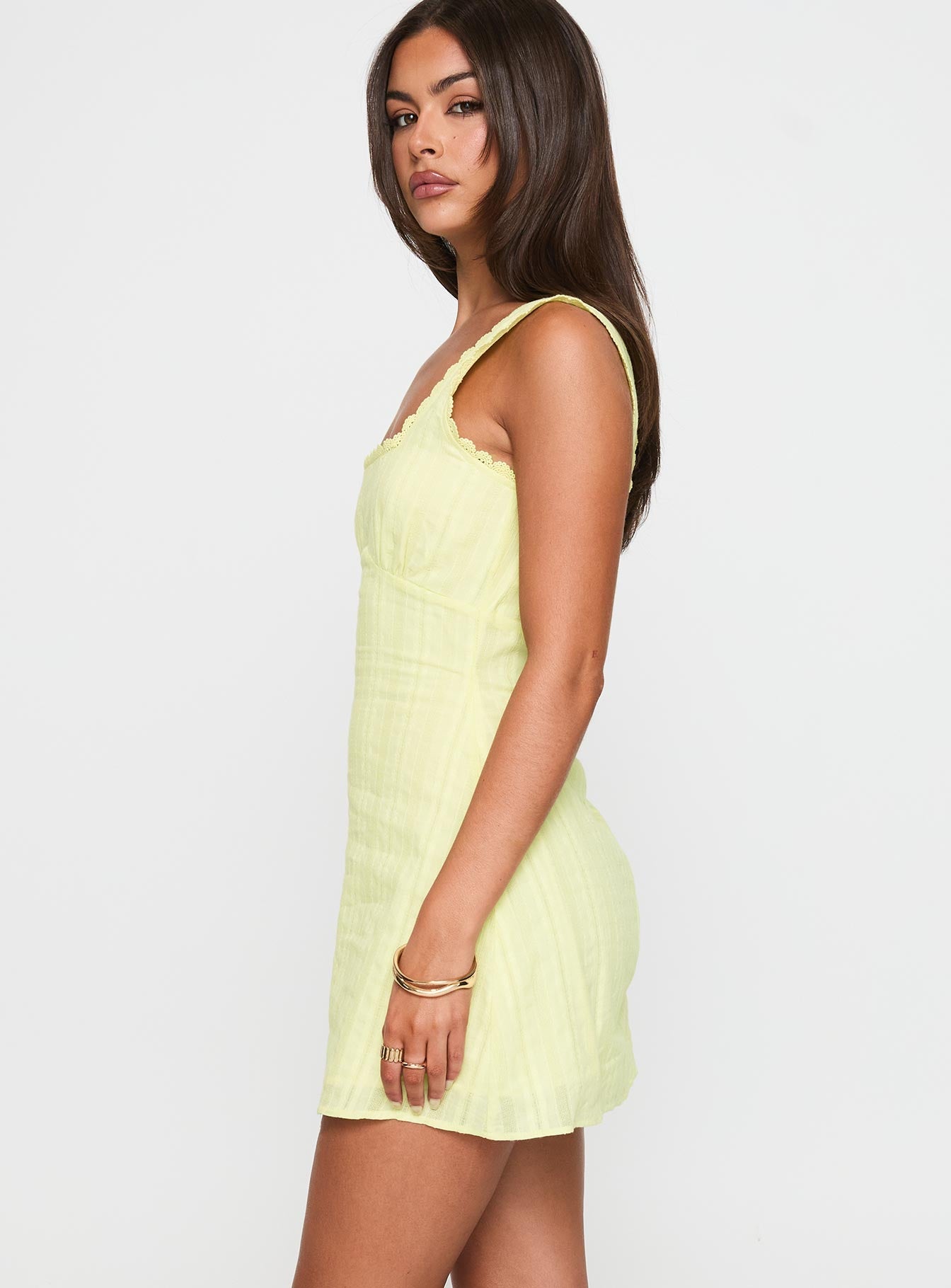 side view of model wearing Princess Polly Dasha Mini Dress Lemon Square Neck 
