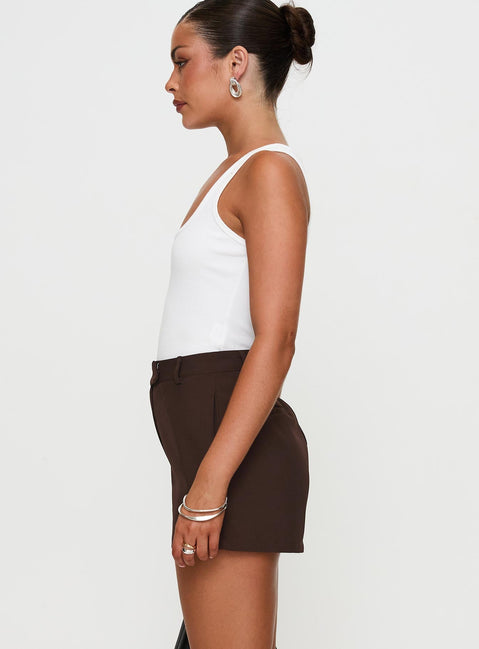side view of model wearing Princess Polly Ellerie Tailored Shorts Chocolate High Waisted Shorts 