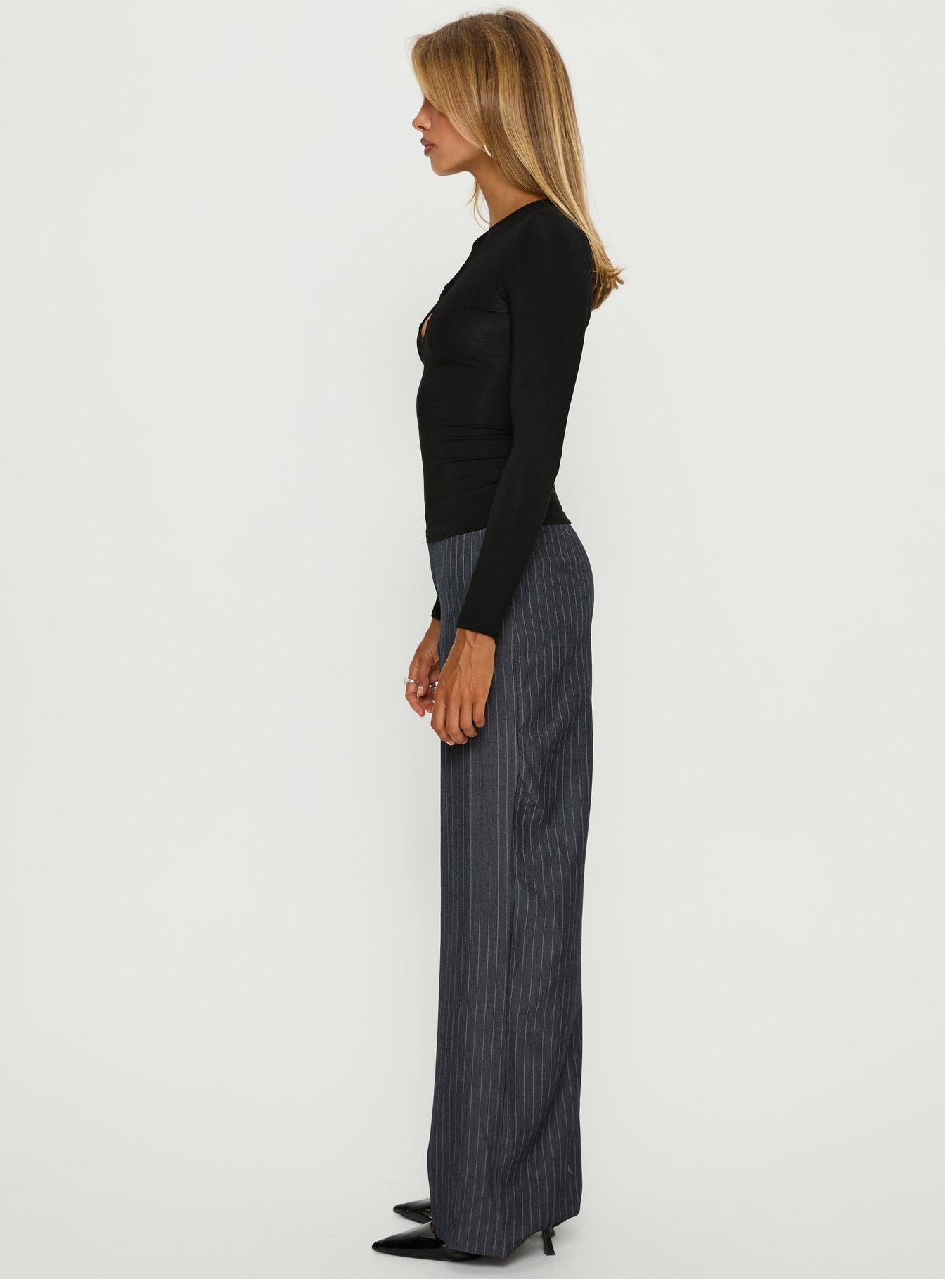 side view of model wearing Princess Polly Khane Low Rise Wide Leg Pant Charcoal Pinstripe Mid Rise Pants 