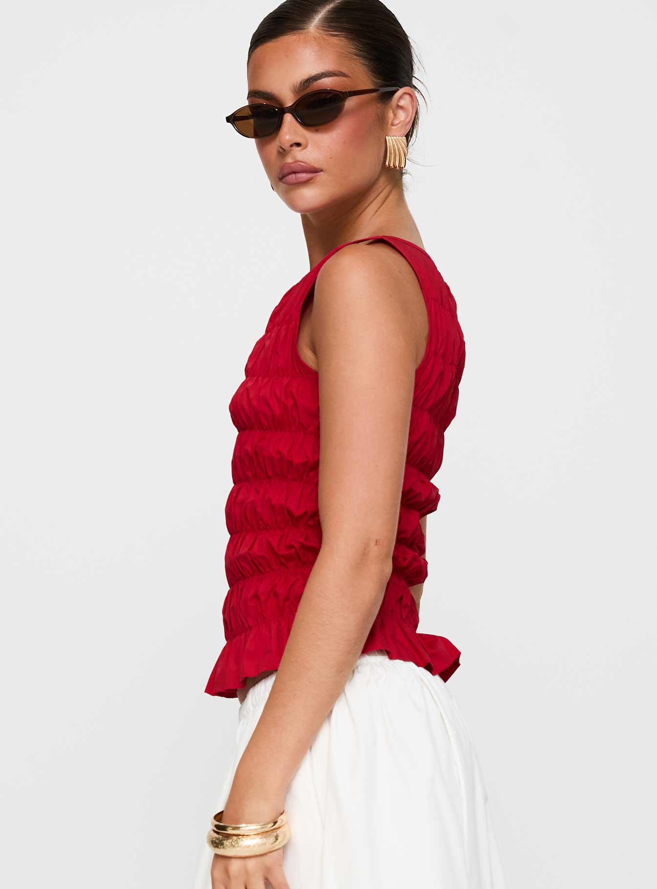 side view of model wearing Princess Polly Marleene Shirred Top Red Sleeveless Crew Neck 