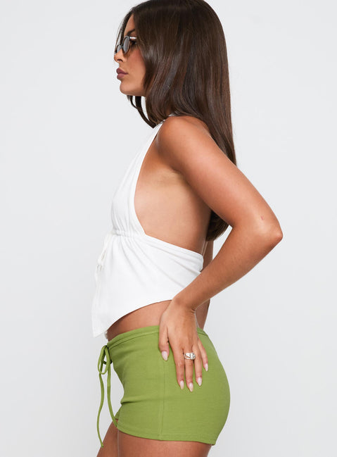 side view of model wearing Princess Polly Obviously Halter Top White Sleeveless Plunger 