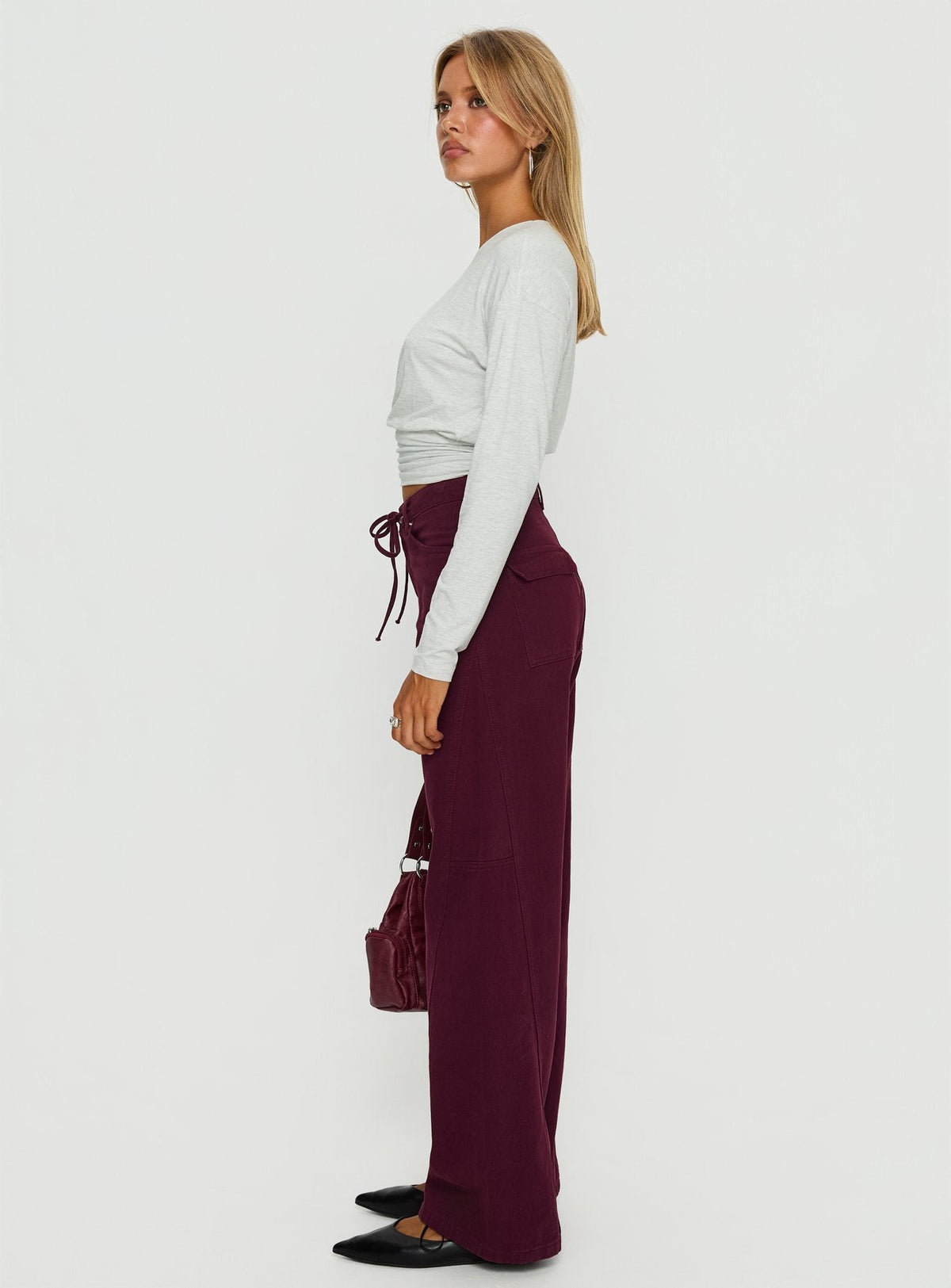side view of model wearing Princess Polly Bruiser Tie Waist Mid Rise Wide Leg Jeans Currant High Rise Jeans Jeans 