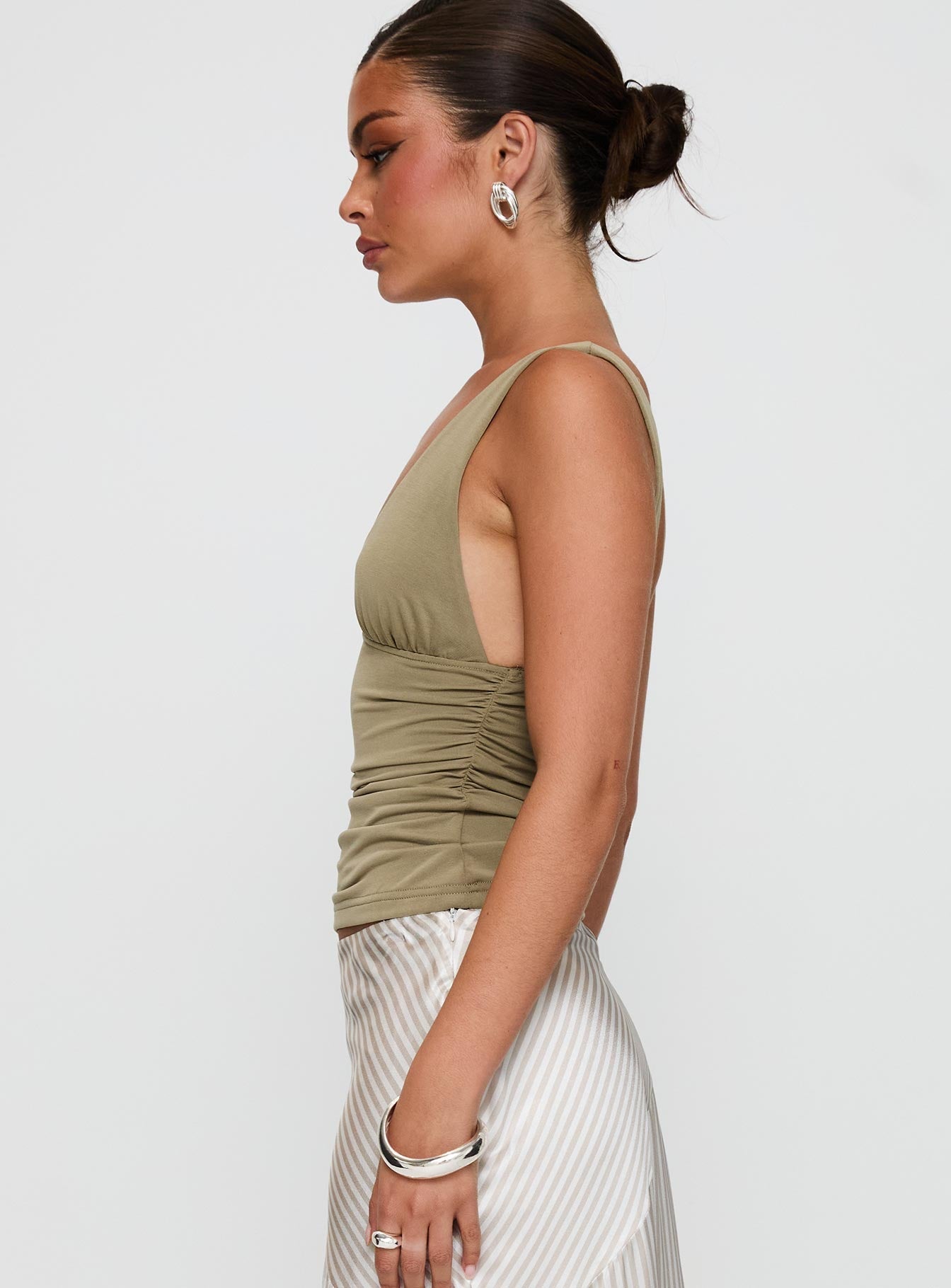 side view of model wearing Princess Polly Sublime Ruched Top Green Sleeveless Plunger 