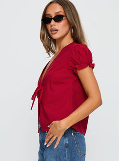 side view of model wearing Princess Polly Starstruck Tie Up Top Red Short Sleeves V-Neck 