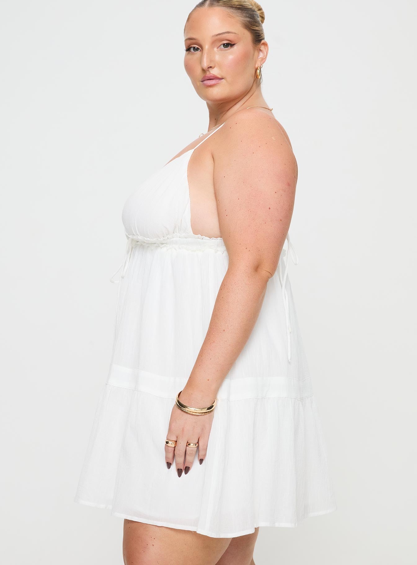 side view of model wearing Princess Polly Dionne Mini Dress White Curve Plunger 