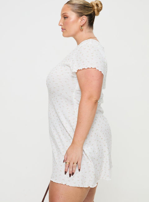 side view of model wearing Princess Polly Patton Mini Dress White Floral Curve Crew Neck 