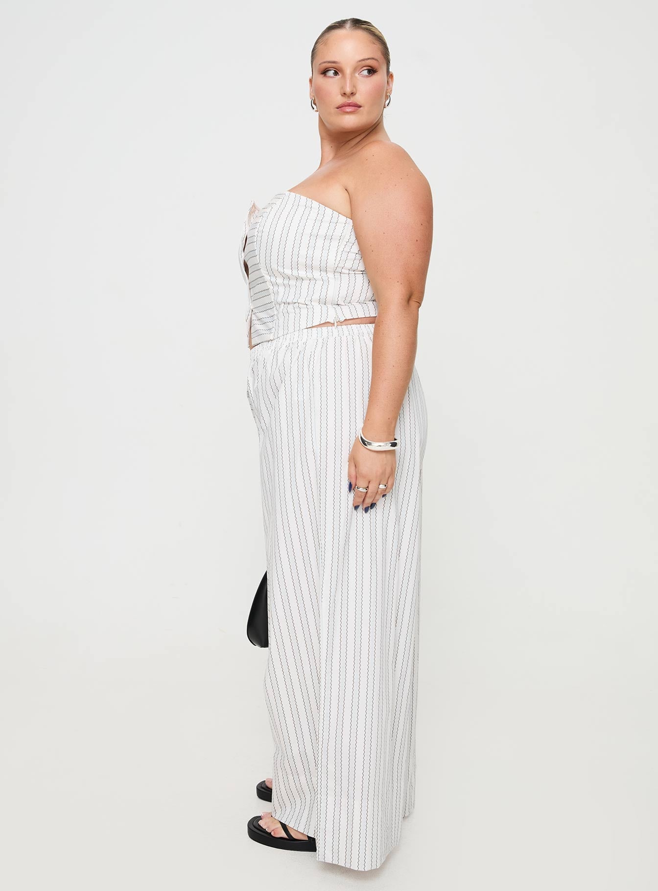 side view of model wearing Princess Polly Boarder Pants White Stripe Curve High Waisted Pants 