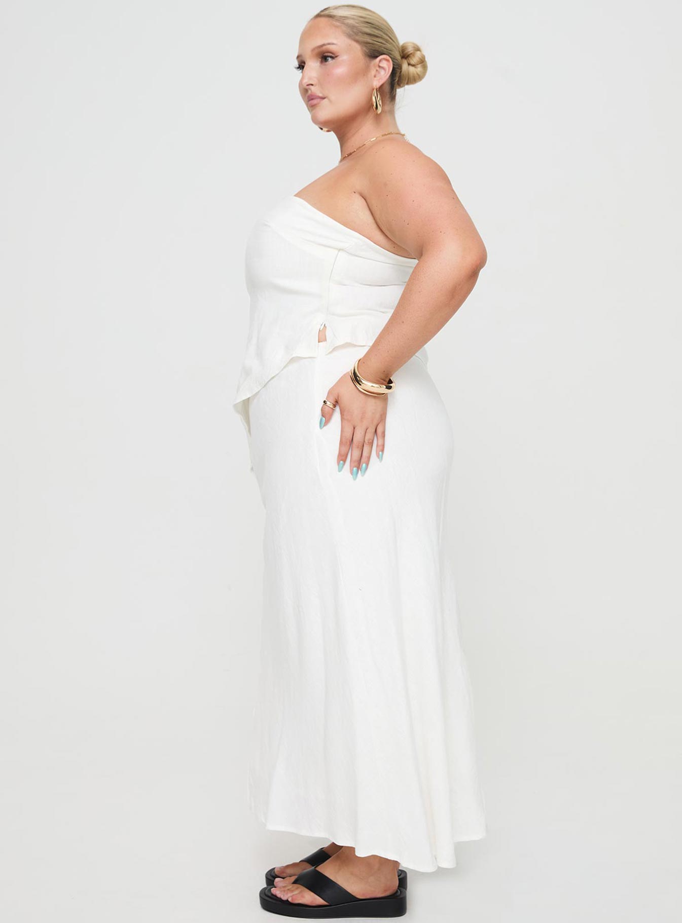   side view of model wearing Princess Polly Ermias Linen Blend Midi Skirt White Curve Maxi 