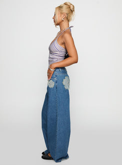 side view of model wearing Princess Polly A Keeper Flower Patch Jeans Mid Blue Low Rise Jeans 