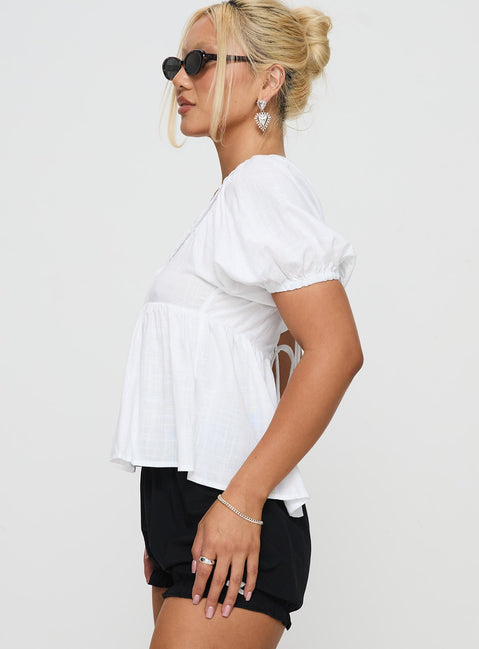 side view of model wearing Princess Polly Weyes Smock Top White Short Sleeves Scoop Neck 