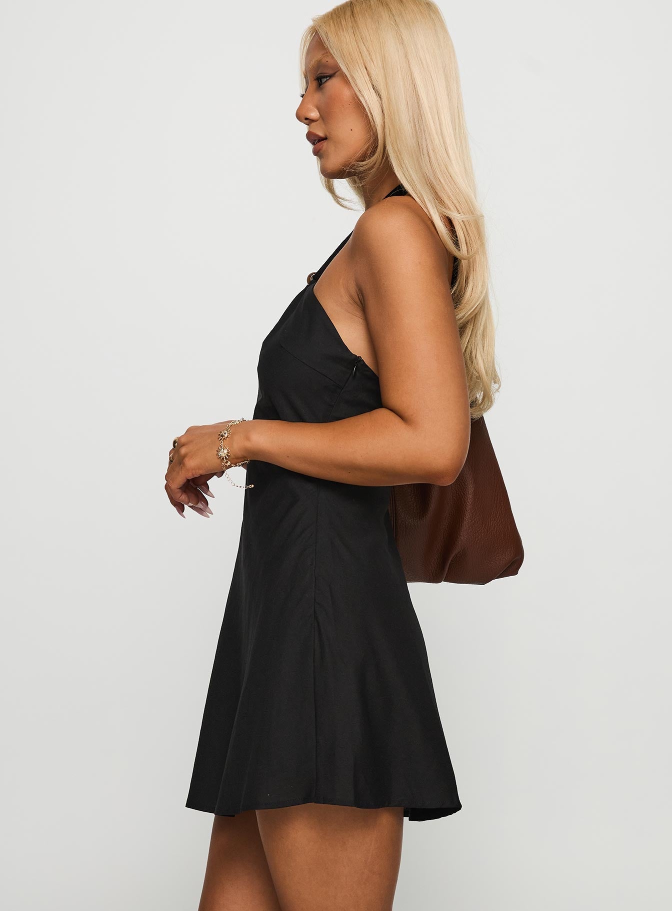 side view of model wearing Princess Polly Loleila Halter Mini Dress Black Asymmetric Neckline 