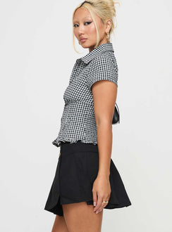   side view of model wearing Princess Polly Anubis Pleat Mini Skirt Black Mini Skirts 