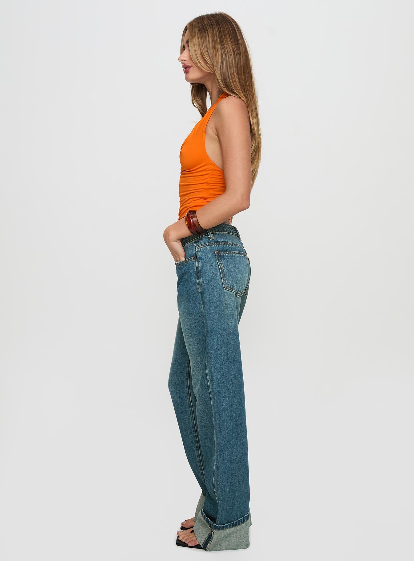 side view of model wearing Princess Polly Toros Mid Rise Wide Leg Foldover Denim Jeans Mid Blue Low Rise Jeans 