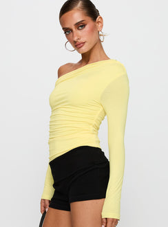 side view of model wearing Princess Polly Beller Long Sleeve Top Lemon Full Sleeves Asymmetric Neckline 