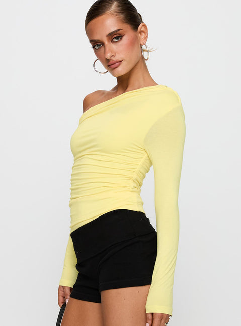 side view of model wearing Princess Polly Beller Long Sleeve Top Lemon Full Sleeves Asymmetric Neckline 