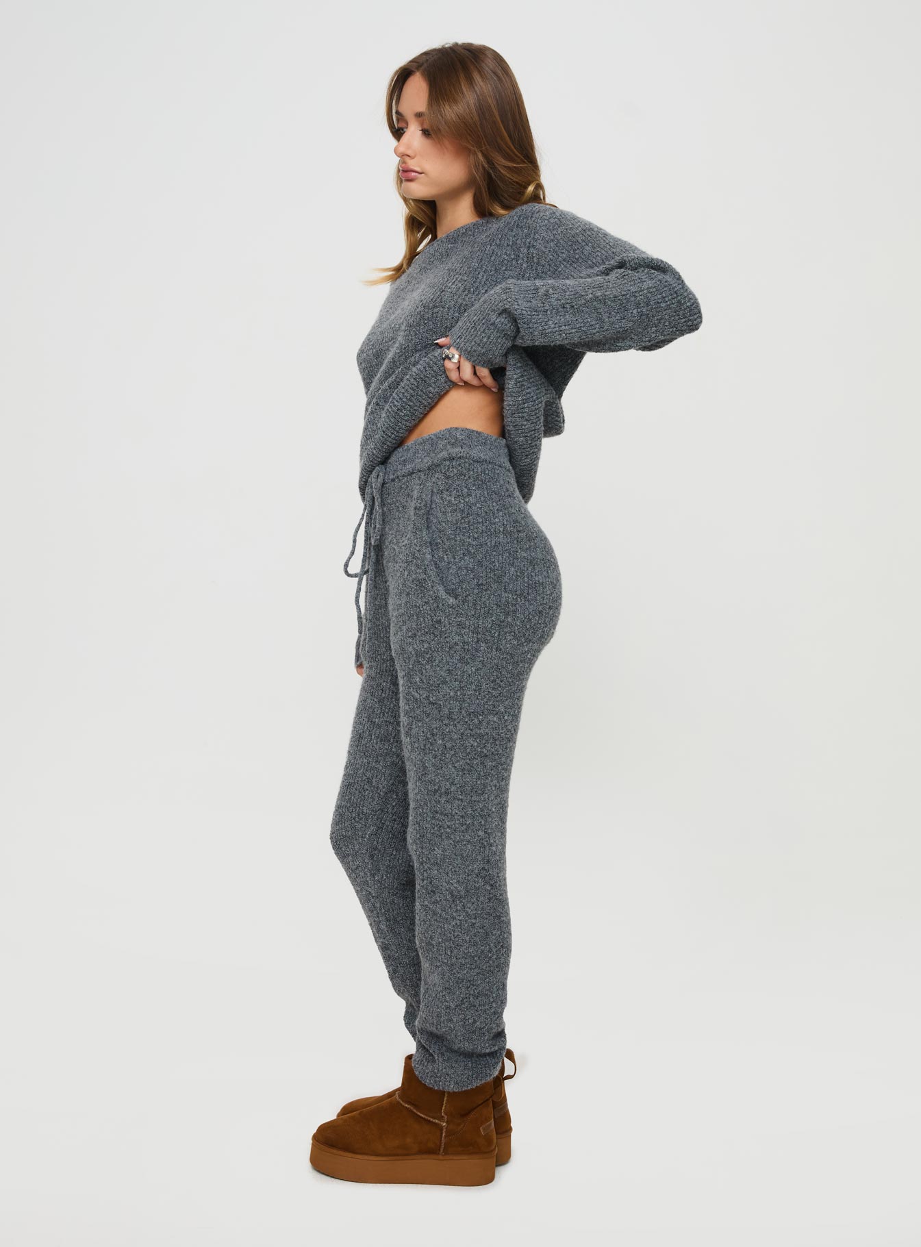 side view of model wearing Princess Polly Abrams Rib Knit Pants Charcoal Marle High Waisted Pants 