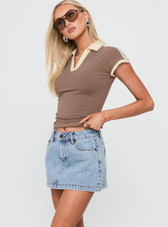   side view of model wearing Princess Polly Nicolina Low Rise Denim Mini Skirt Ice Blue Wash Tall Mini Skirts 