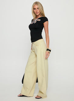 side view of model wearing Princess Polly Ramos Low Rise Wide Leg Jeans Butter Lemon Low Rise Jeans 