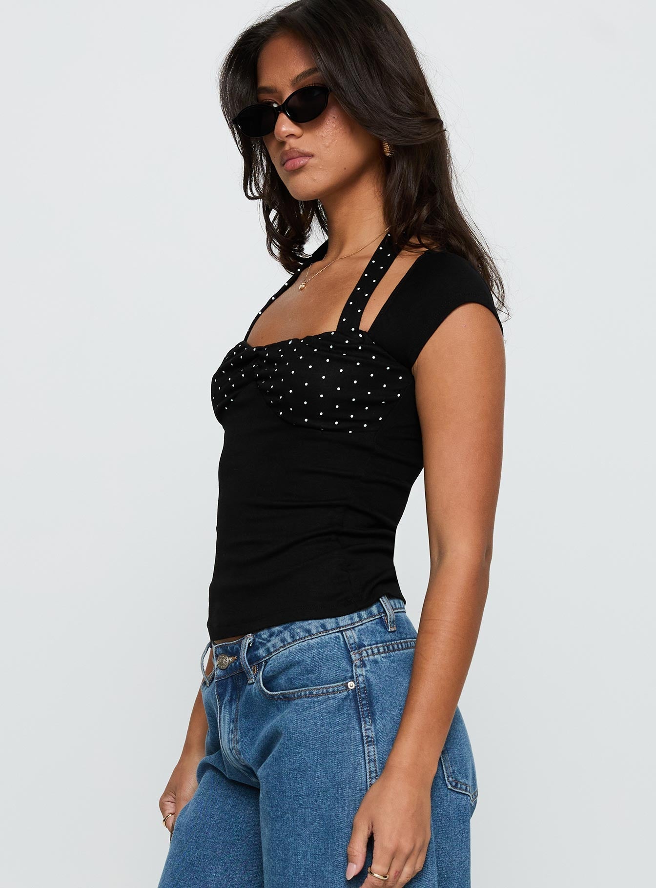 side view of model wearing Princess Polly Emberglow Top Black / Polka Short Sleeves Square Neck 