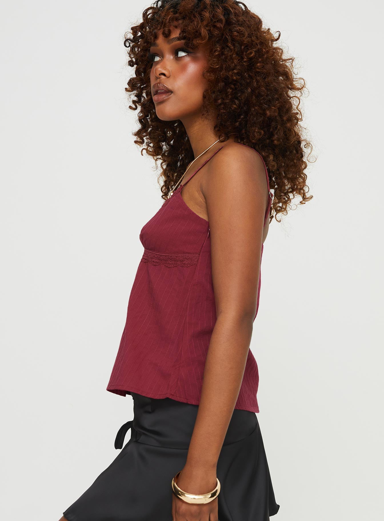 side view of model wearing Princess Polly Lunya Top Burgundy Petite Sleeveless V-Neck 
