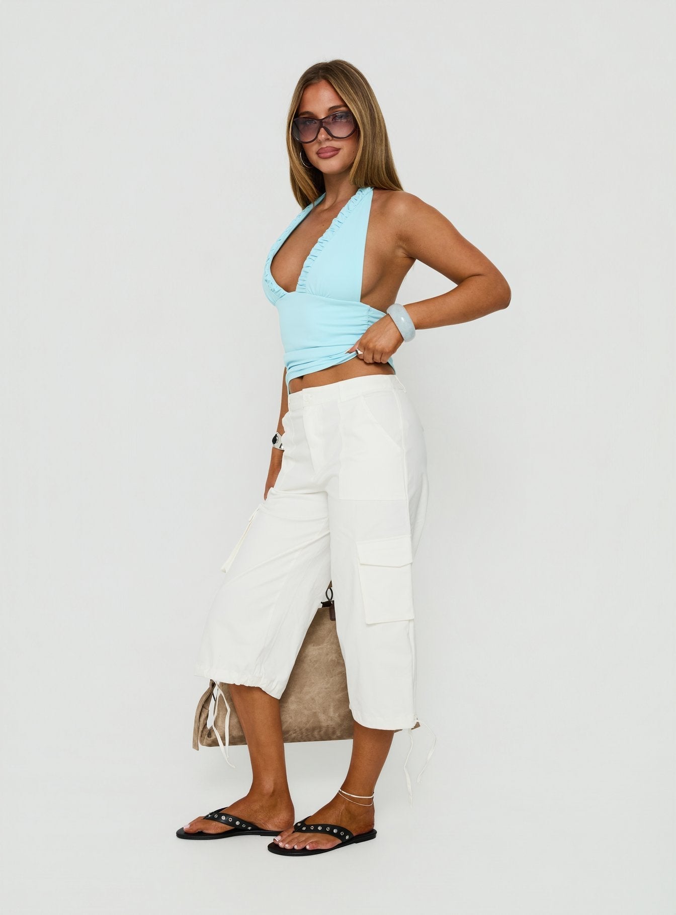 Crafted from Alfonza Utility Capri White womens-regular-pants in mid-rise cargo style side view of model wearing Princess Polly