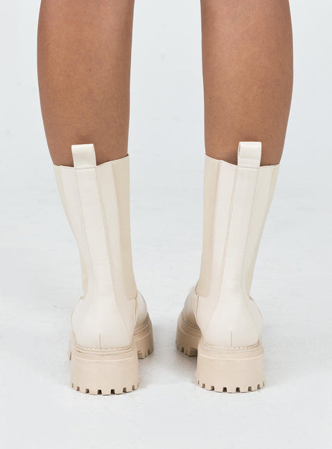 Boots Faux leather material Rounded toe Platform base Ankle pull tab Slip on style