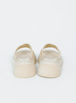 Flats Faux leather material  Cross strap upper  Platform base 