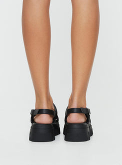 Faux leather sandals Rounded toe, chunky treaded sole, buckle fastening at ankle