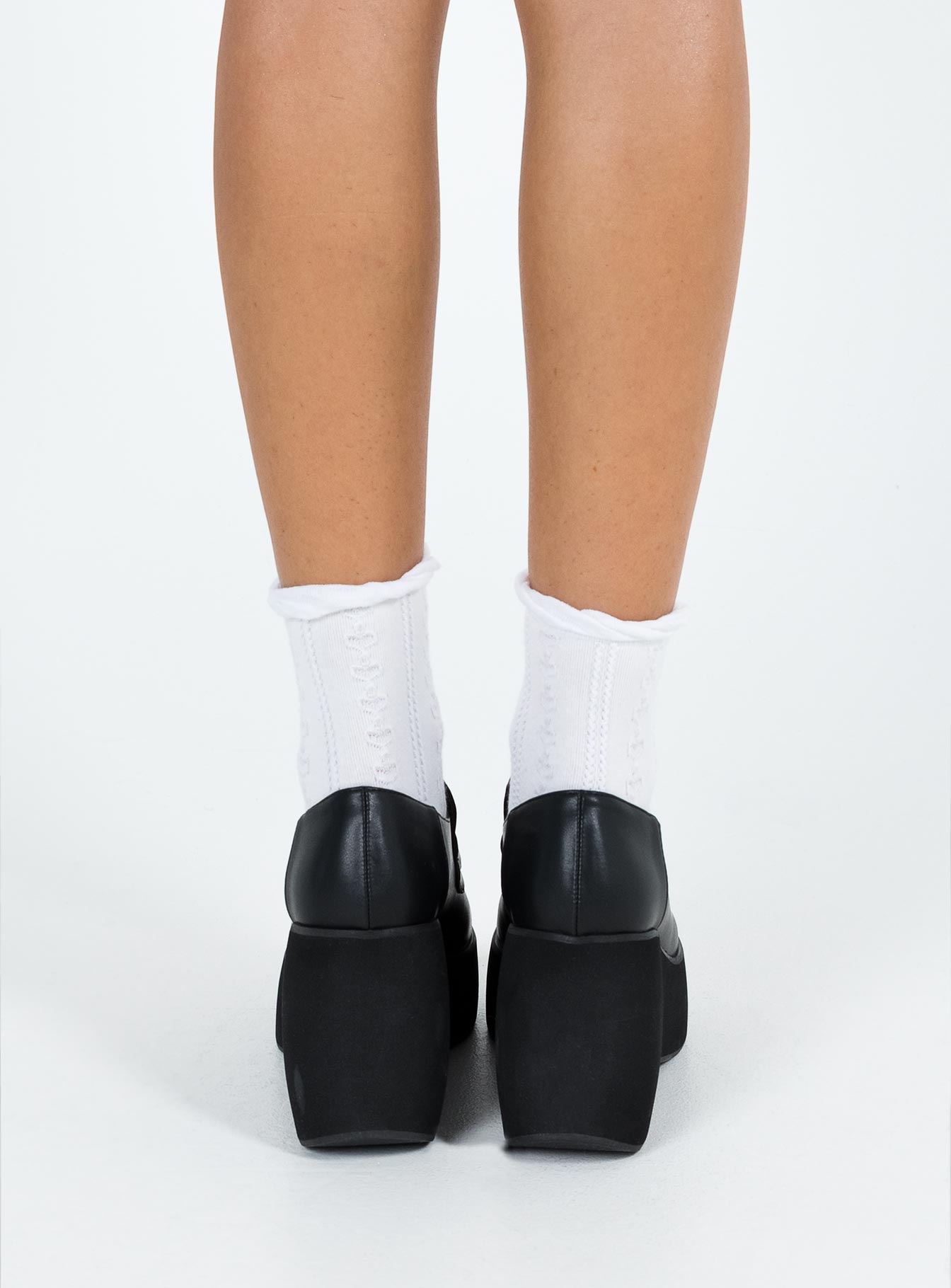 Platform loafer Faux leather material Exaggerated platform base Rounded toe Padded footbed