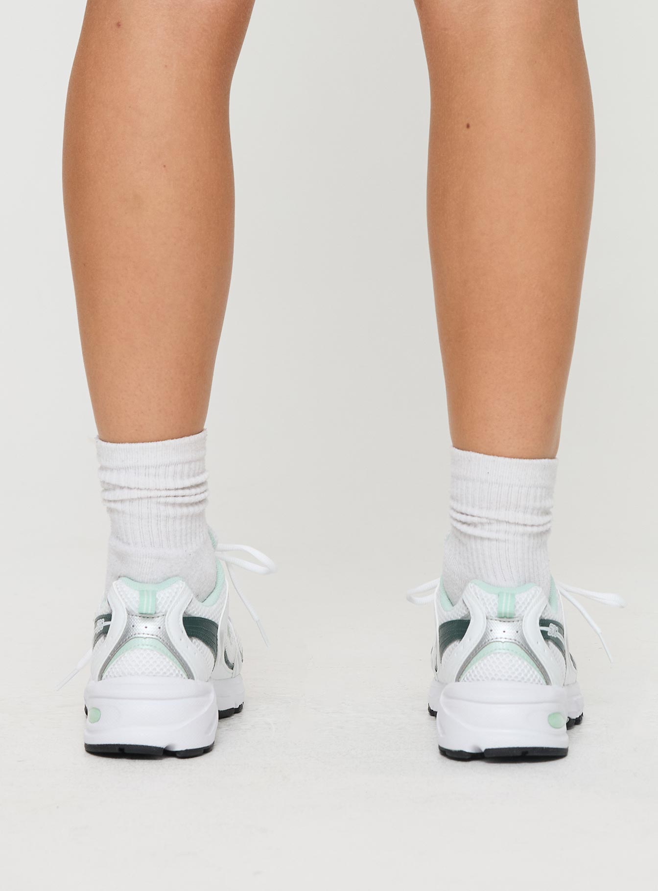 Mesh netting throughout, lace-up fastening, pull tab at heel