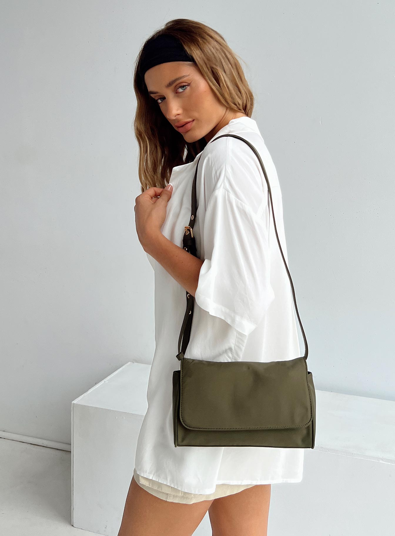 Crossbody bag Adjustable crossbody strap Gold-toned hardware Magnetic button fastening Internal zip pocket & card slip  Flat base