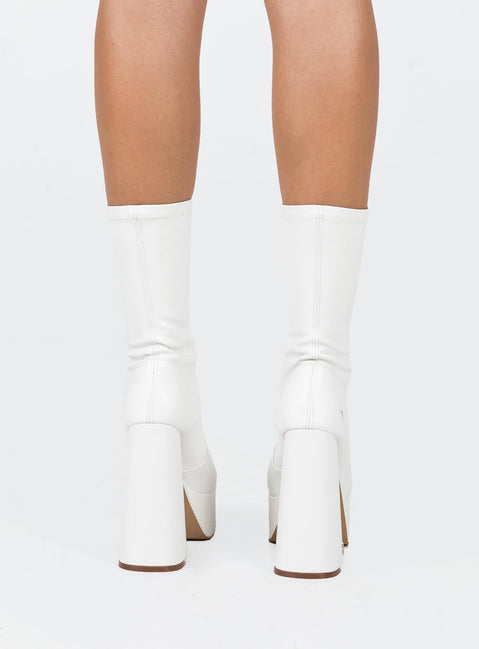 Boots  Faux leather material  Fitted at leg  Block heel  Platform base  Square toe  Slight stretch 