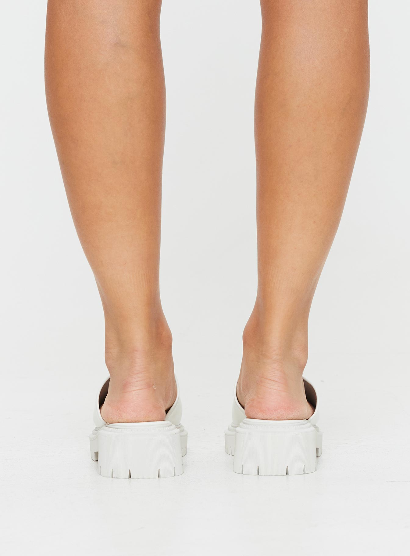 Faux leather slides Single thick strap upper, rounded toe, treaded sole, padded footbed