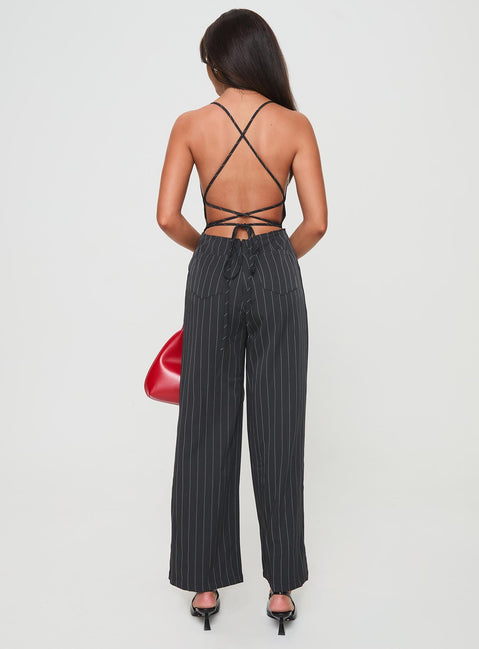 Jumpsuit fastening at back, invisible zip fastening, twin hip &amp; back pockets, partially exposed back, straight leg