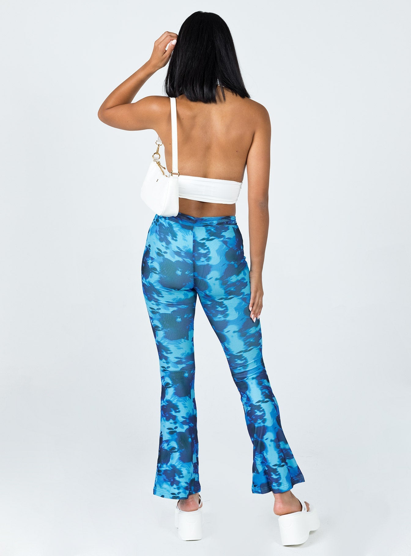 back view of model wearing Princess Polly Allen Floral Flare Pants Blue 