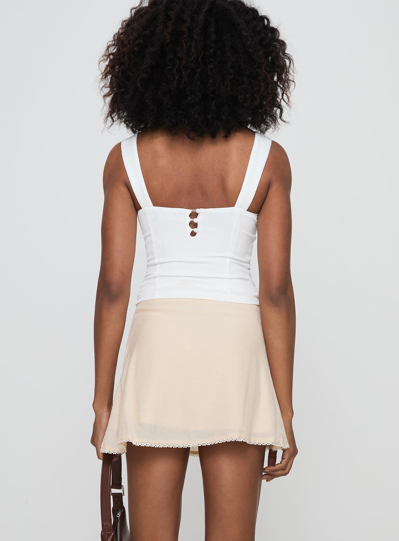 back view of model wearing Princess Polly Foalie Ruffle Mini Skirt Beige Mini Skirts 