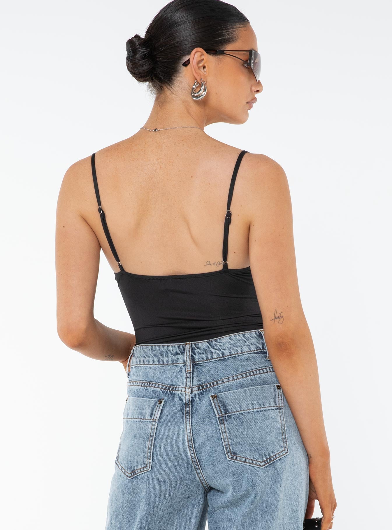 back view of model wearing Princess Polly Dalsi Bodysuit Black Sleeveless V-Neck 