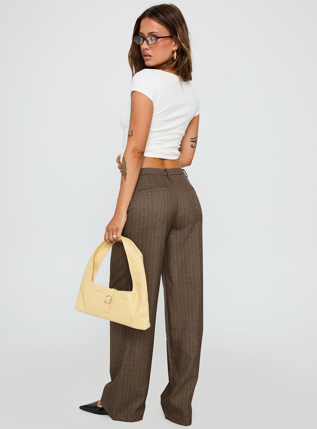 back view of model wearing Princess Polly Broadcast Pants Beige Pinstripe Low Rise Pants 