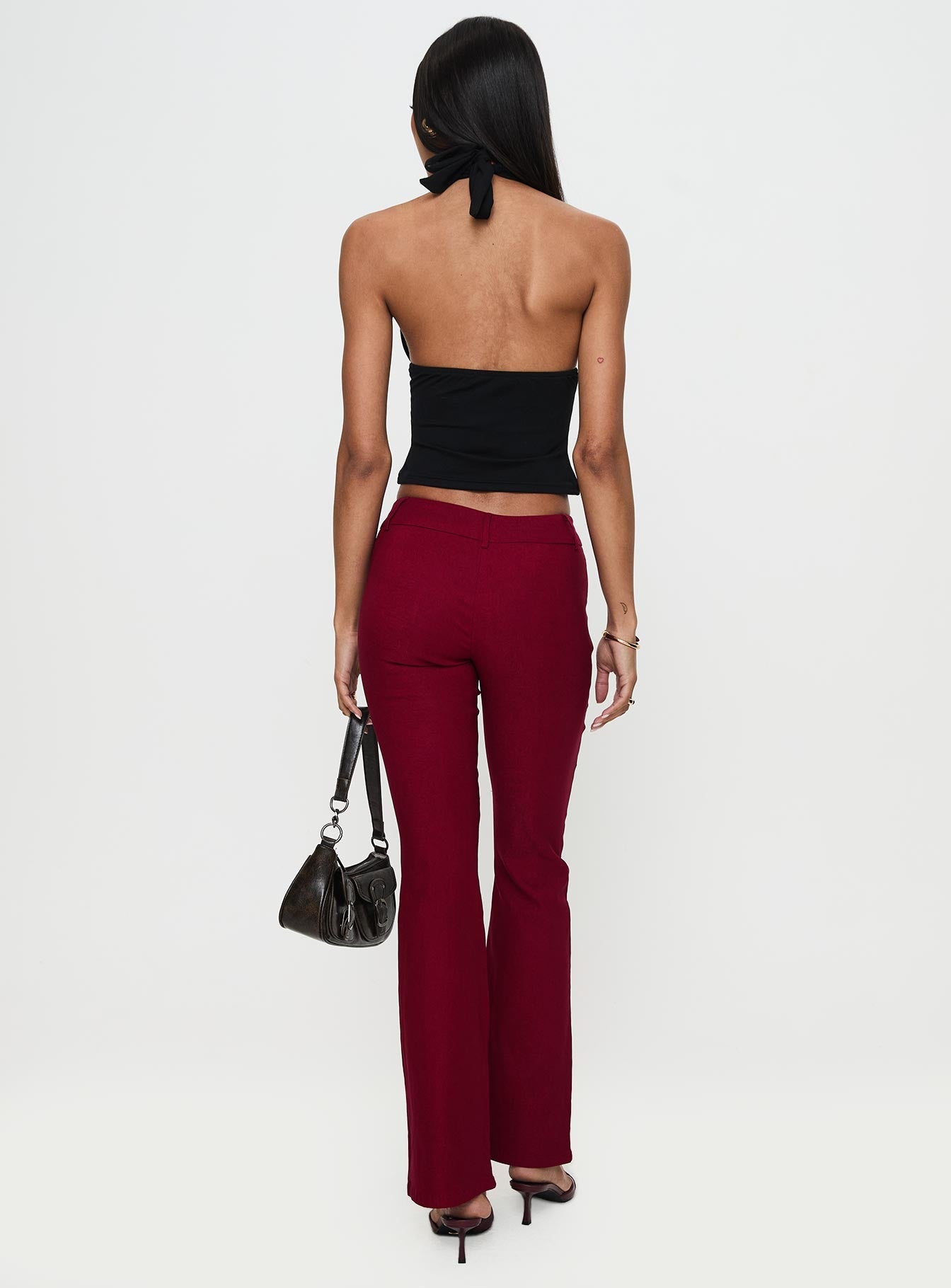 back view of model wearing Princess Polly Kinkirk Flared Pants Burgundy Low Rise Pants 