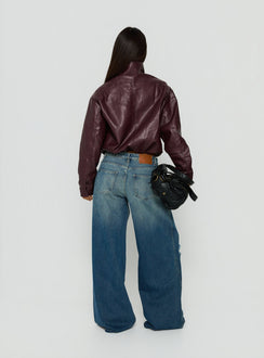 Presenting the Ramos Low Rise Wide Leg Distressed Jeans Dark Indigo womens-jeans back view of model wearing Princess Polly