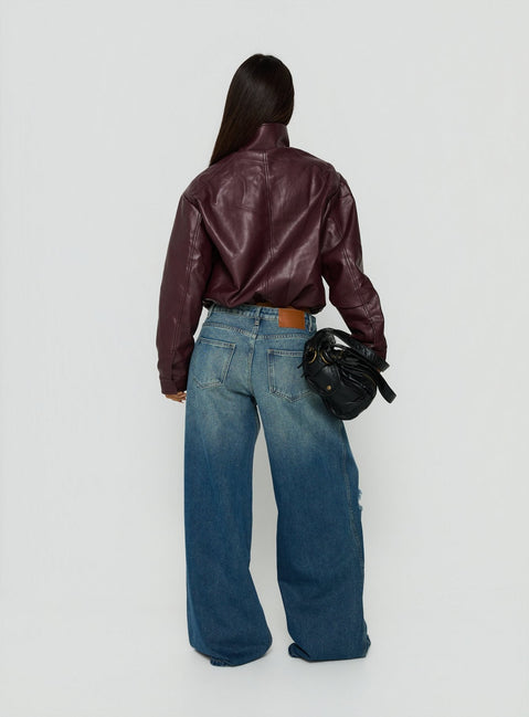 Presenting the Ramos Low Rise Wide Leg Distressed Jeans Dark Indigo womens-jeans back view of model wearing Princess Polly