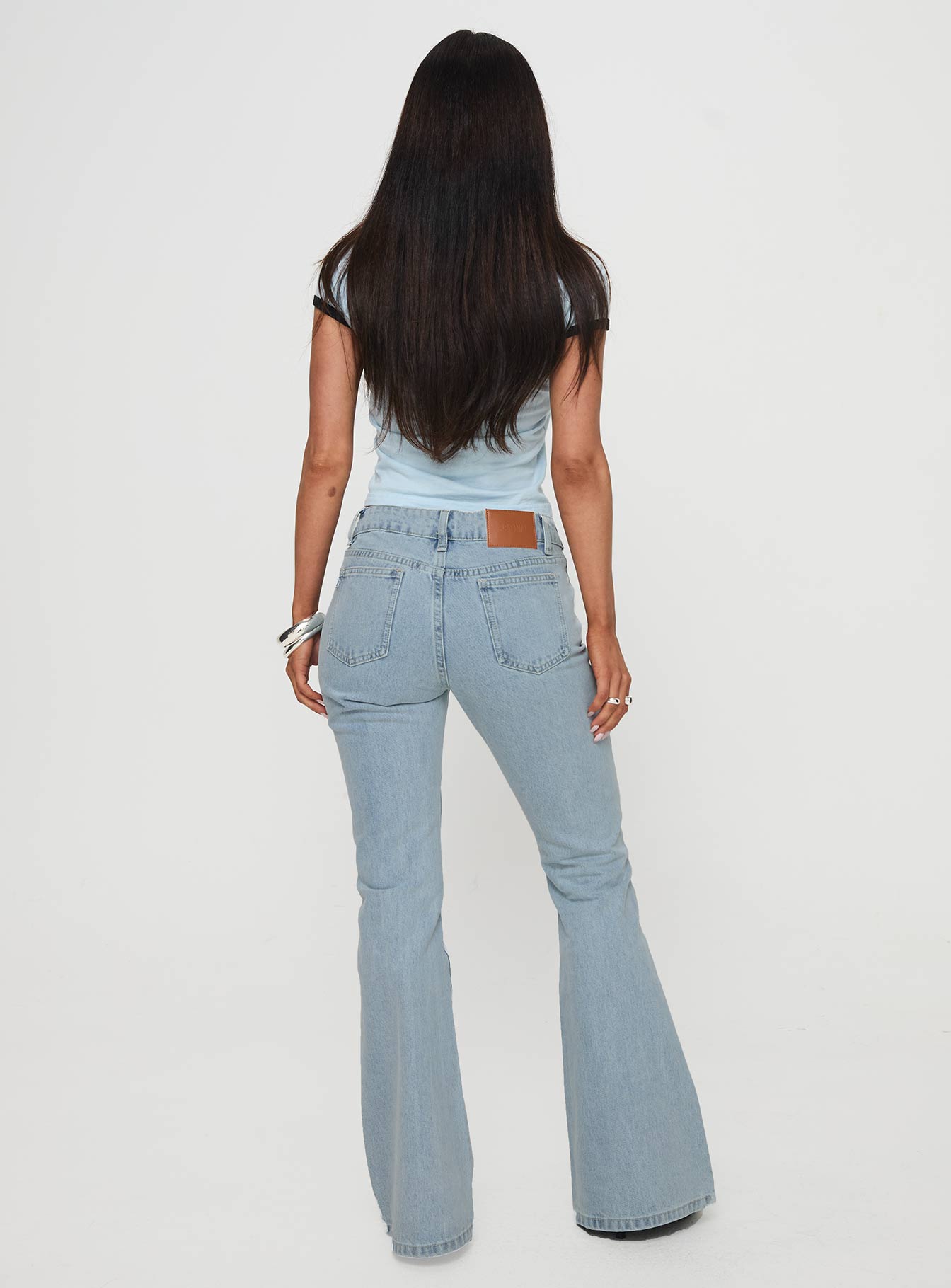 back view of model wearing Princess Polly Echovalley Low Rise Jeans Light Wash Mid Rise 