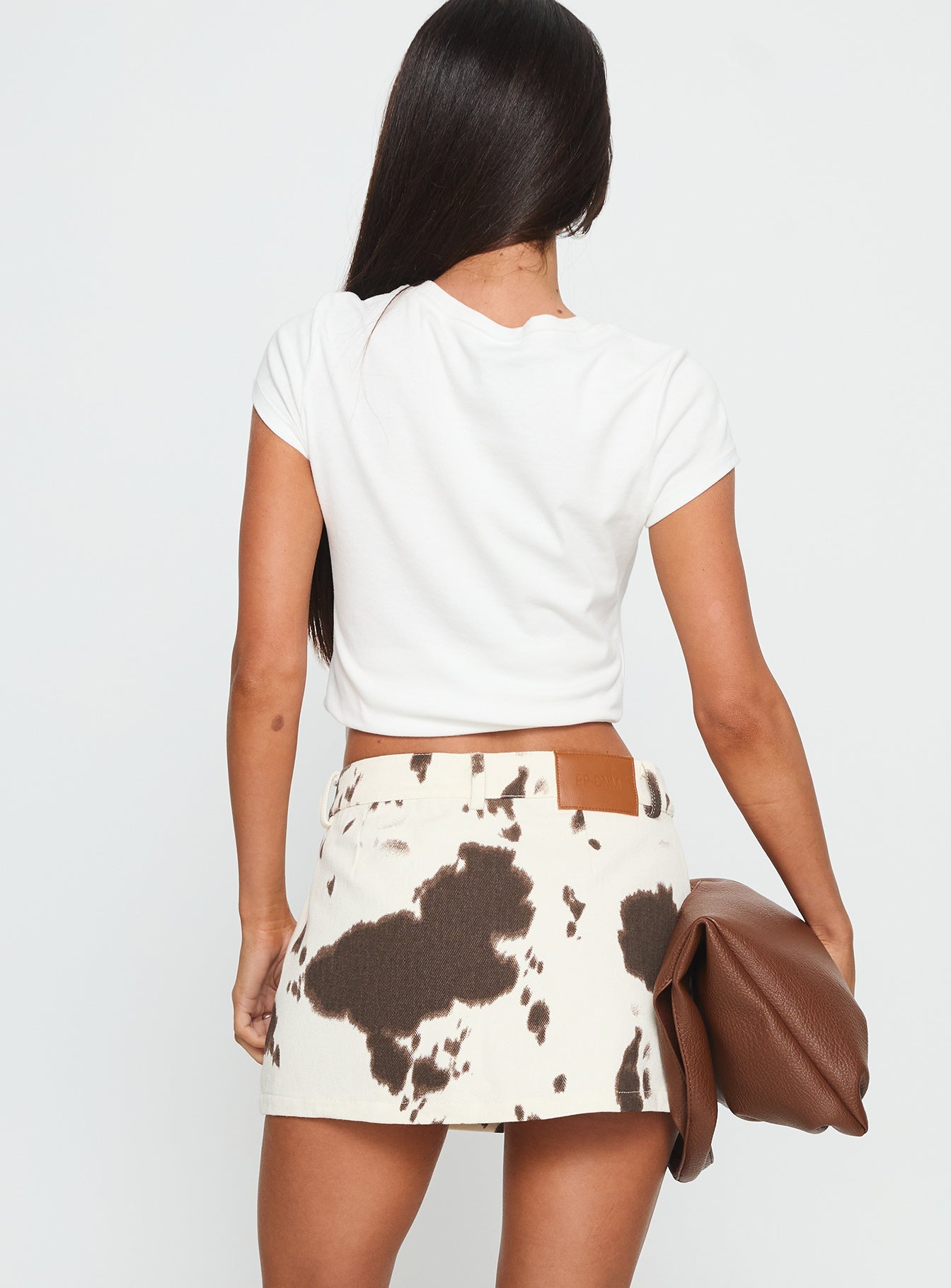 back view of model wearing Princess Polly Maxa Denim Mini Skirt Cow Print Mini Skirts 