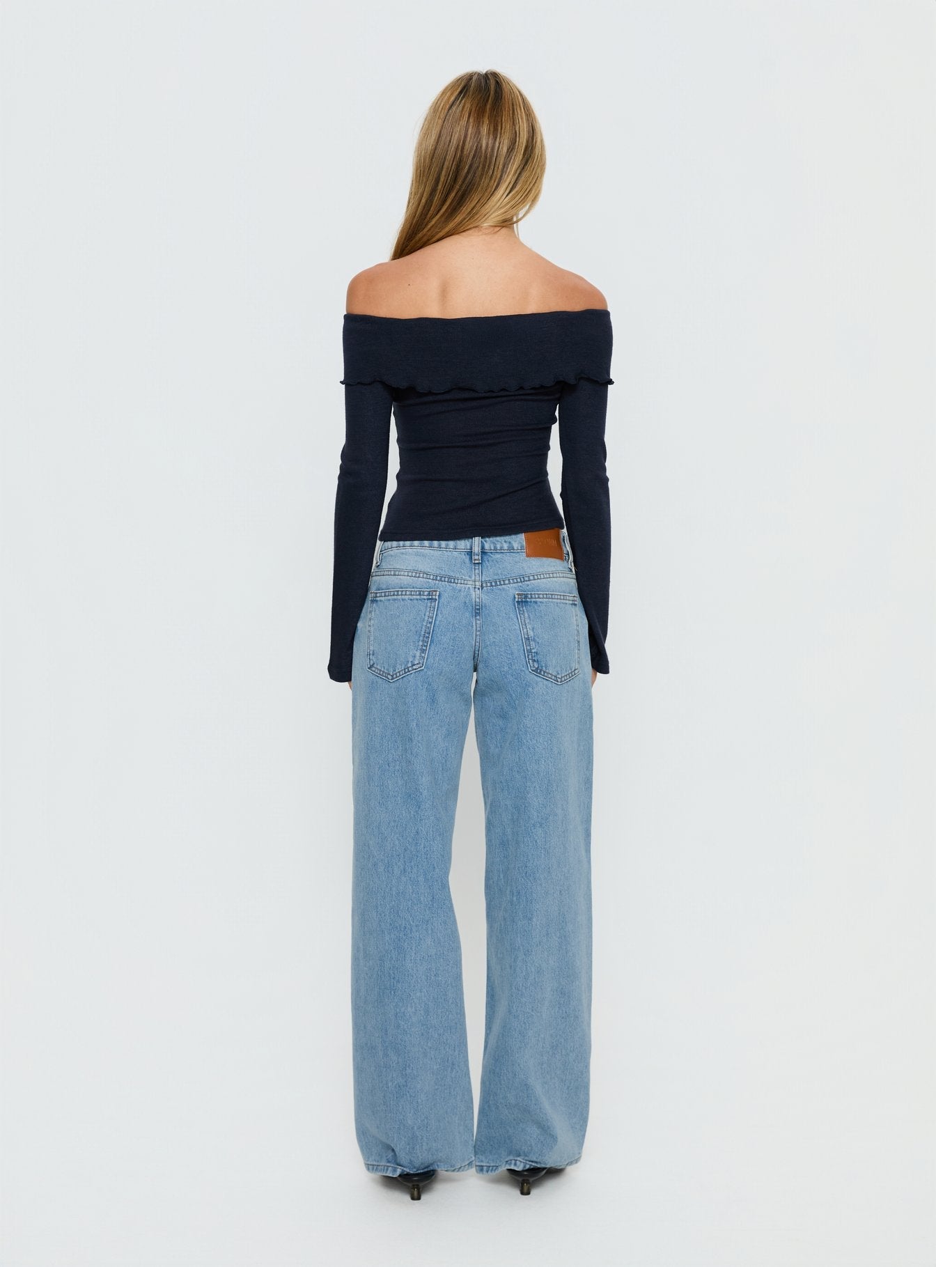 back view of model wearing Princess Polly Ellanor Low Rise Slouch Denim Jean Washed Mid Blue Wash Low Rise Jeans 