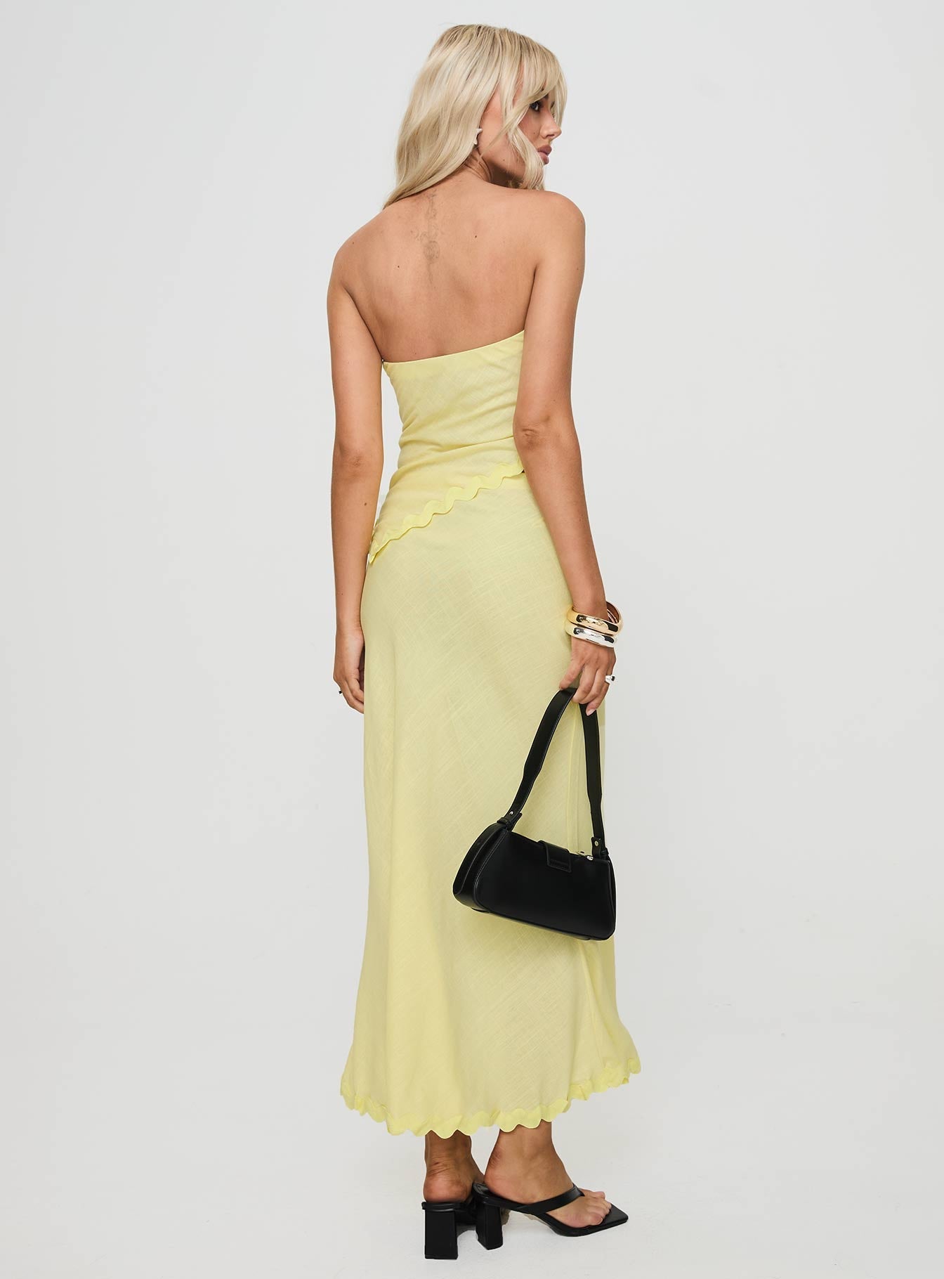 back view of model wearing Princess Polly Silvershore Maxi Skirt Yellow Maxi 
