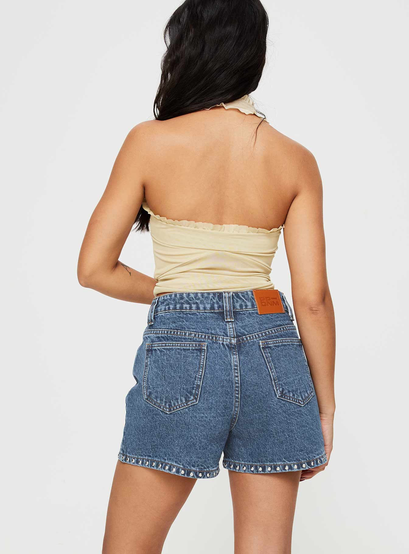 Denim shorts High rise fit, silver studded detailed, classic five pocket design, belt loops at waist, zip and button fastening, branded patch at back