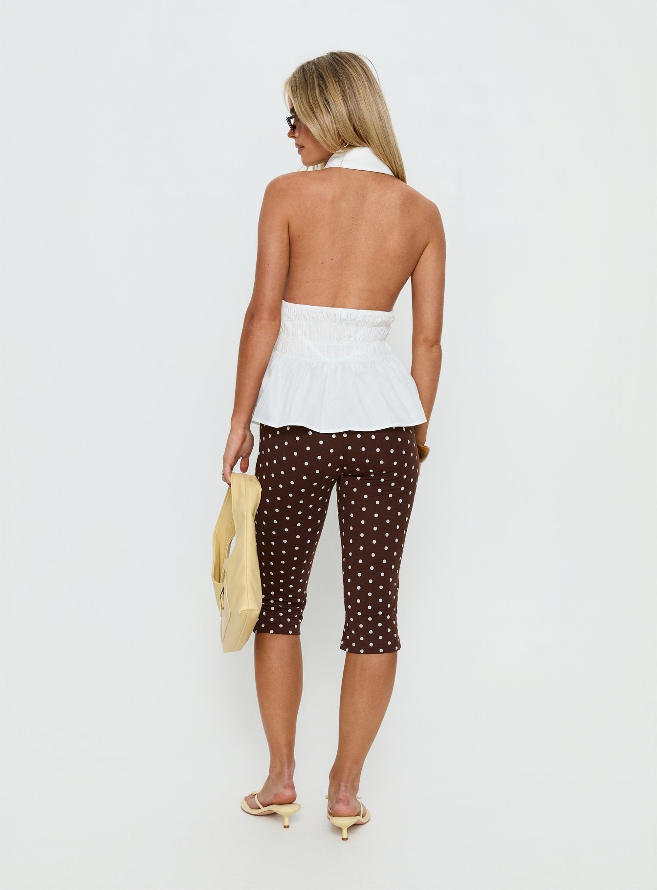 back view of model wearing Princess Polly Samaira Capri Pant Brown Polka Dot Mid Rise Pants 