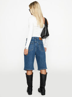 back view of model wearing Princess Polly Retro Dream Mid Rise Longline Denim Shorts Mid Wash Low Rise Shorts 