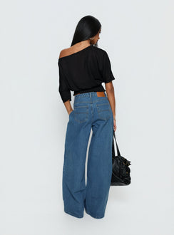 back view of model wearing Princess Polly Naylor Mid Rise Wide Leg Jeans Mid Blue Wash Mid Rise Jeans 